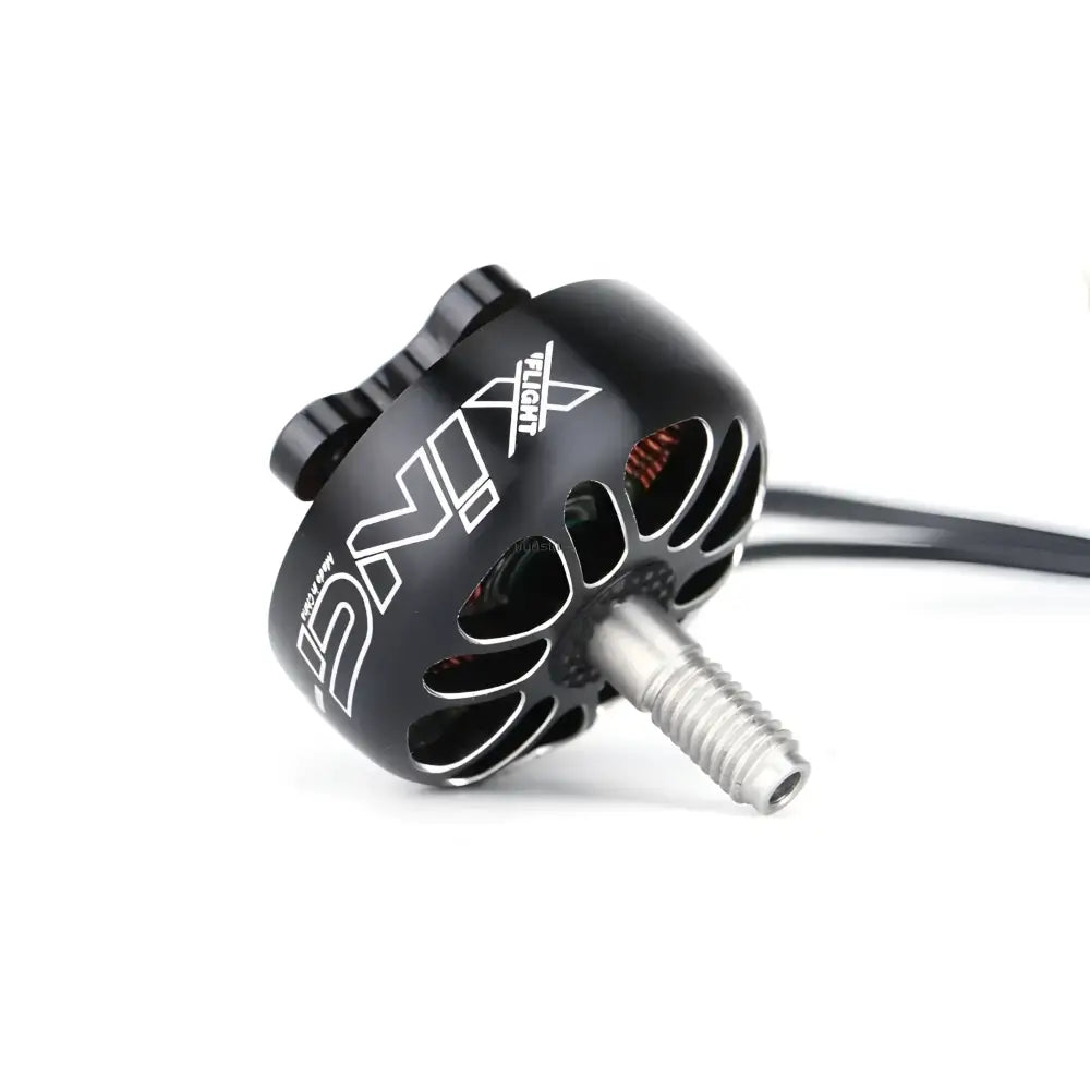 Black cylindrical drone motor with cooling vents and a protruding shaft.